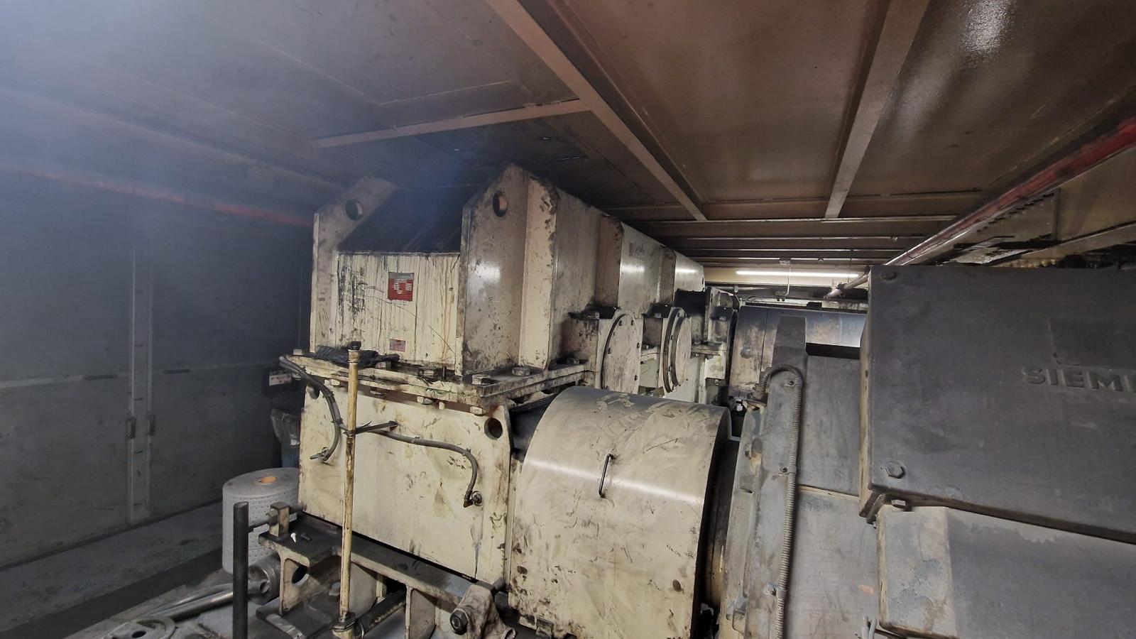 Large industrial equipment prepared for relocation inside plant