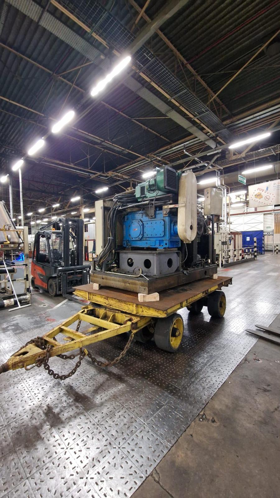 Industrial machine moved on wheeled platform during relocation