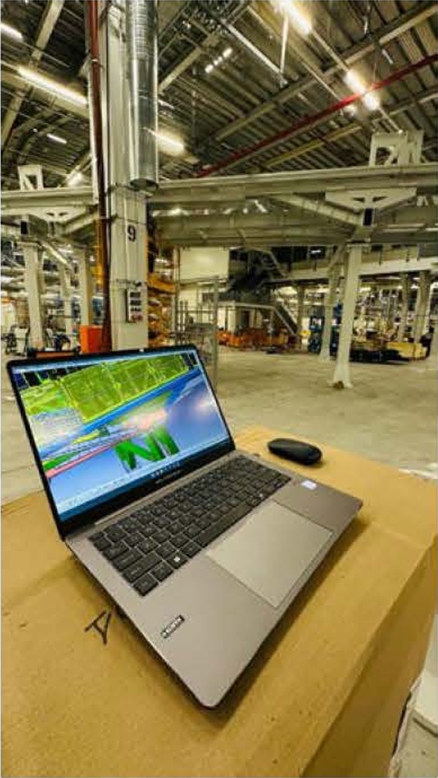 Laptop and industrial production site used for project coordination